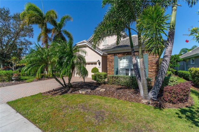 view of front of house with a garage and a front yard