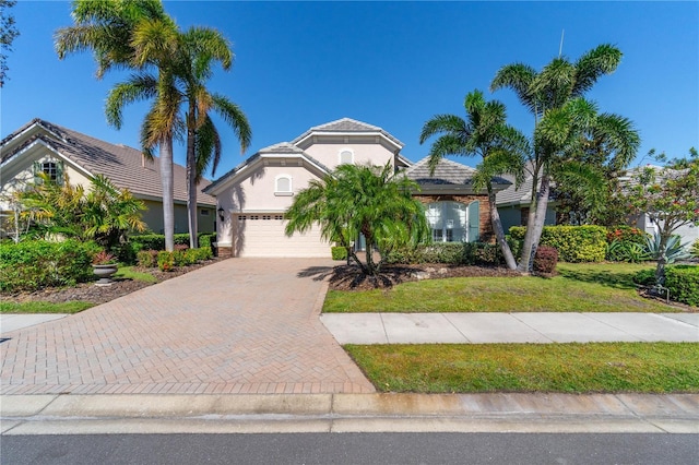 mediterranean / spanish-style home featuring a front yard