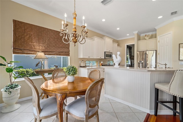 dining space featuring crown molding, plenty of natural light, light tile patterned floors, and an inviting chandelier