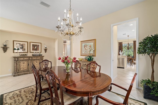 dining room with light tile patterned flooring and an inviting chandelier