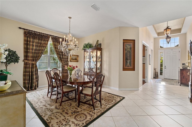 dining room featuring a wealth of natural light, light tile patterned flooring, and a notable chandelier