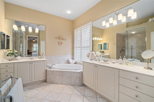 bathroom featuring tile patterned floors, ceiling fan, vanity, and shower with separate bathtub