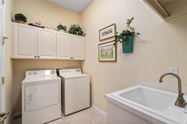 laundry area featuring cabinets, independent washer and dryer, sink, and light tile patterned floors