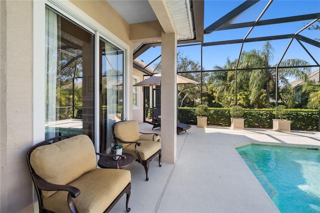 view of swimming pool featuring a patio area and glass enclosure