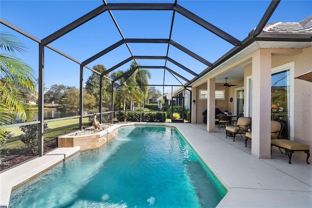 view of pool featuring ceiling fan, a patio, and glass enclosure