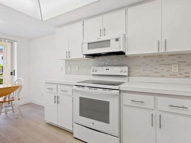 kitchen featuring light wood-type flooring, tasteful backsplash, white appliances, a textured ceiling, and white cabinets