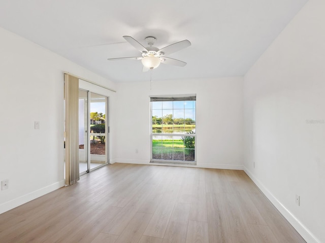 unfurnished room with light hardwood / wood-style floors, a wealth of natural light, and ceiling fan