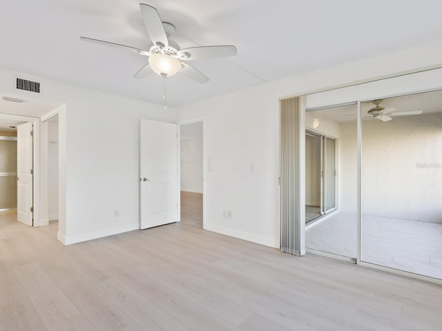 spare room with light wood-type flooring and ceiling fan