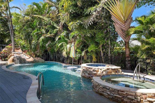 view of swimming pool featuring an in ground hot tub and pool water feature