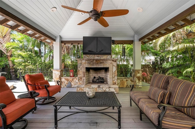 exterior space featuring an outdoor living space with a fireplace, a gazebo, and ceiling fan