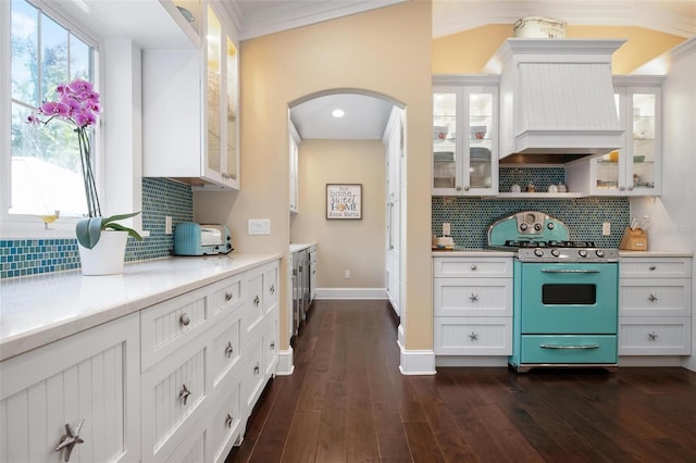 kitchen featuring white cabinetry, range, and tasteful backsplash