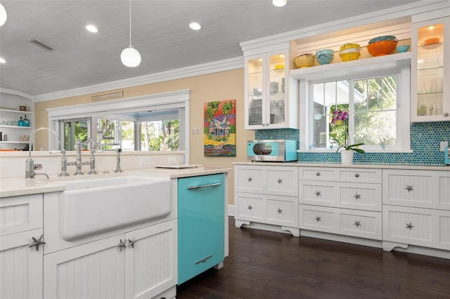 kitchen featuring decorative light fixtures, a healthy amount of sunlight, white cabinetry, and tasteful backsplash