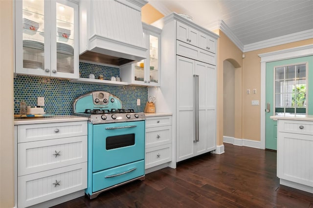 kitchen with white cabinetry, dark wood-type flooring, range, custom exhaust hood, and ornamental molding