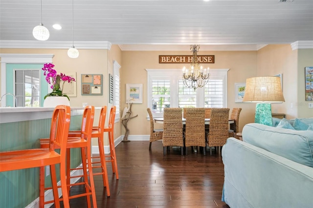 dining space with crown molding, dark wood-type flooring, and a notable chandelier