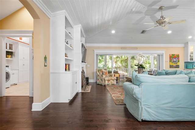 living room with plenty of natural light, dark hardwood / wood-style floors, lofted ceiling, and washer / clothes dryer