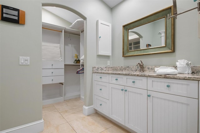 bathroom featuring tile patterned flooring and vanity