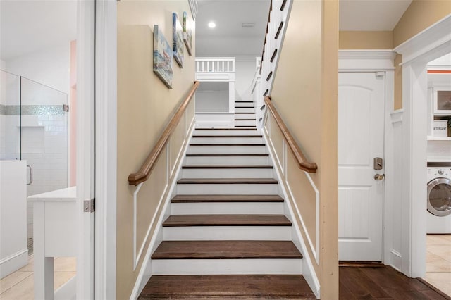 staircase featuring washer / clothes dryer and hardwood / wood-style flooring