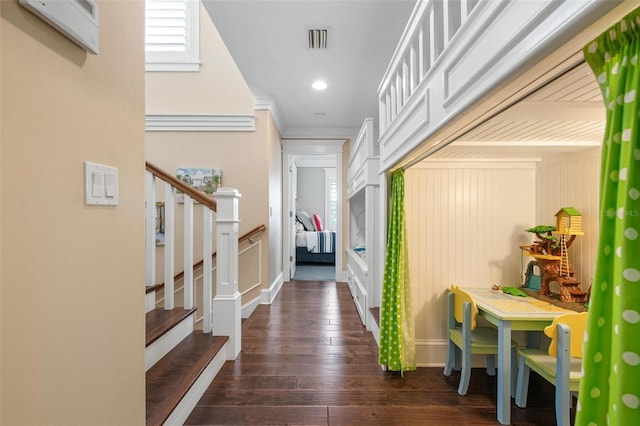 corridor with dark hardwood / wood-style flooring and crown molding