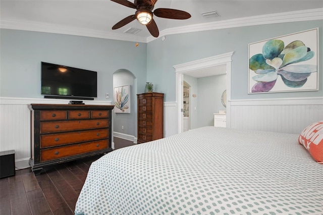 bedroom featuring ceiling fan, crown molding, and dark wood-type flooring