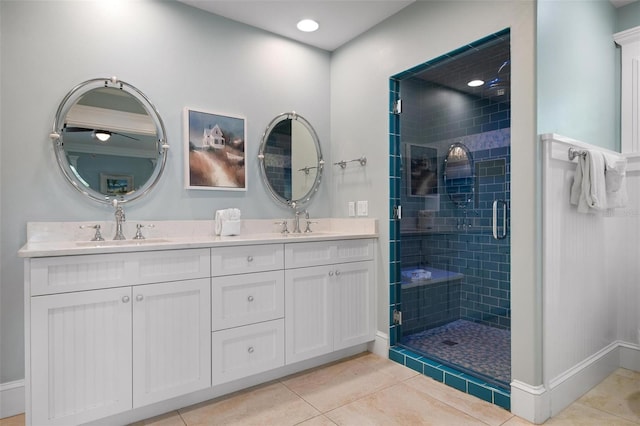 bathroom with tile patterned floors, a shower with door, and vanity