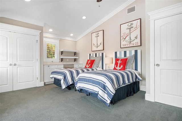 carpeted bedroom featuring a closet, ornamental molding, and vaulted ceiling