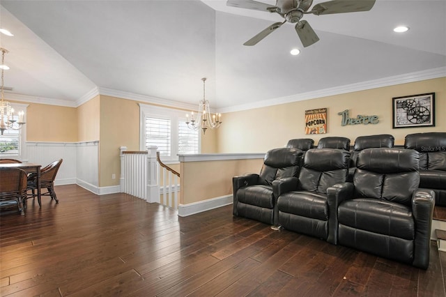 home theater featuring vaulted ceiling, ceiling fan with notable chandelier, dark hardwood / wood-style floors, and ornamental molding