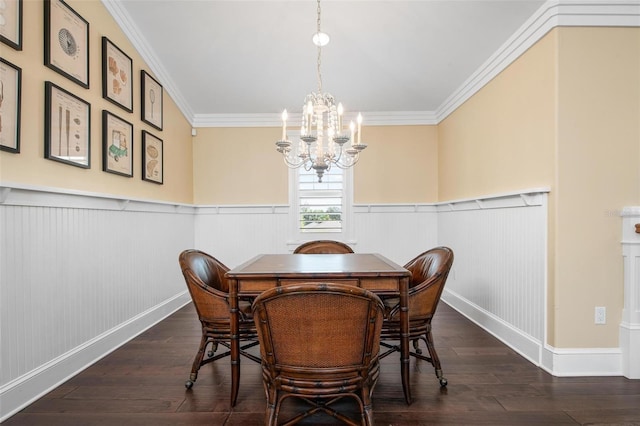 dining space with dark hardwood / wood-style floors, ornamental molding, and a notable chandelier