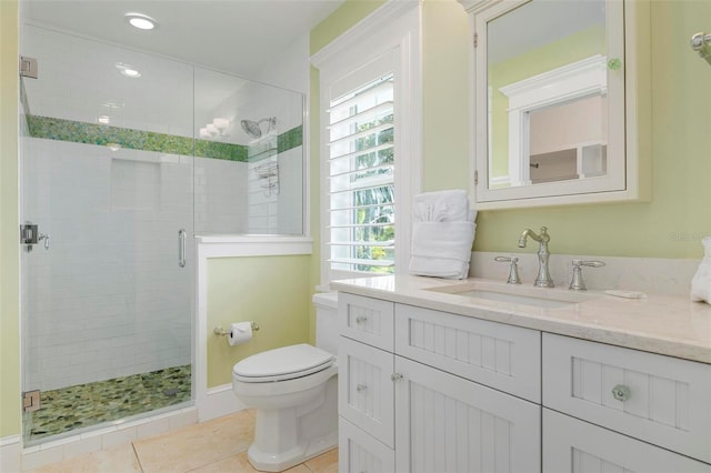 bathroom featuring toilet, vanity, tile patterned floors, and an enclosed shower