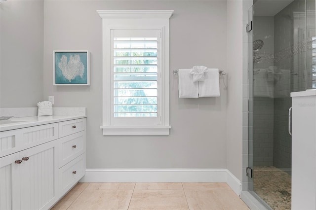 bathroom featuring vanity, tile patterned floors, and a shower with shower door