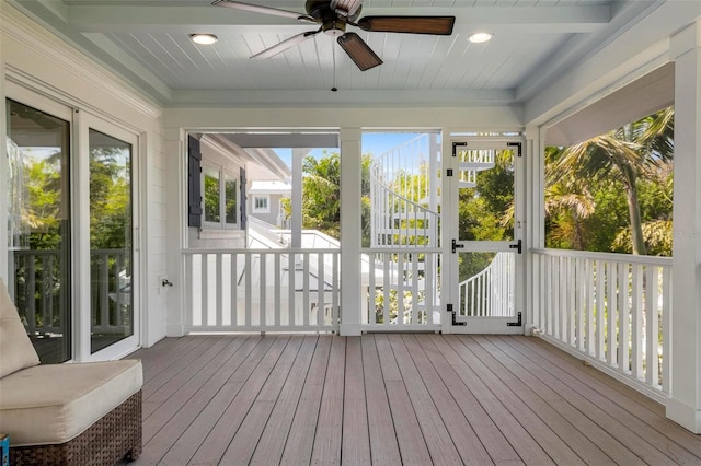 sunroom with beam ceiling and ceiling fan