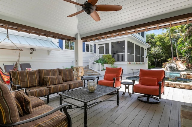 deck featuring a sunroom, an outdoor living space, and ceiling fan