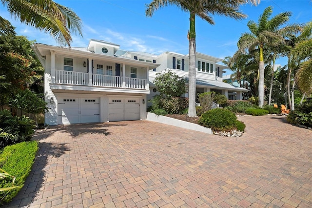 view of front facade with a balcony and a garage