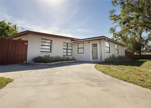 ranch-style home with a front lawn