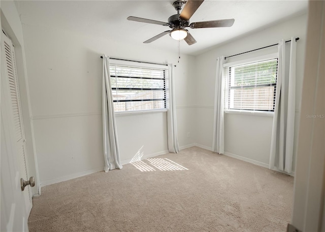 unfurnished bedroom with a closet, light colored carpet, and ceiling fan