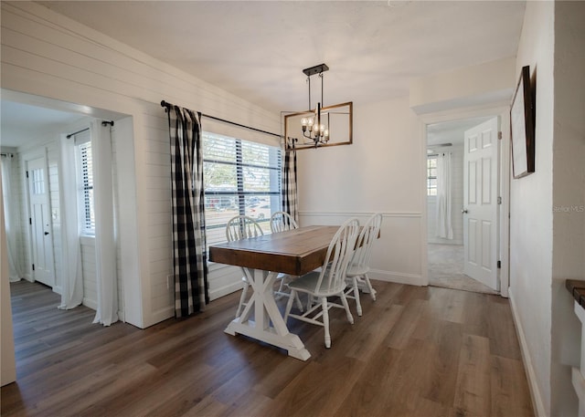 dining room featuring dark hardwood / wood-style floors, a wealth of natural light, and an inviting chandelier