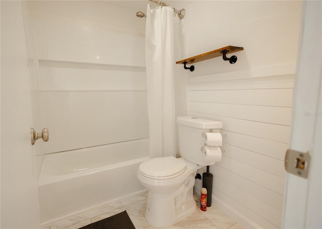 bathroom featuring shower / tub combo and toilet