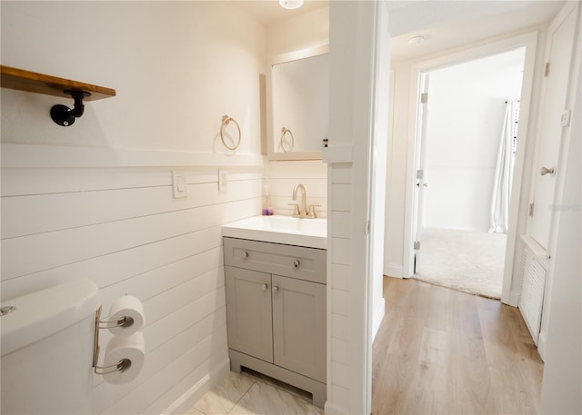 bathroom featuring hardwood / wood-style flooring, vanity, and toilet