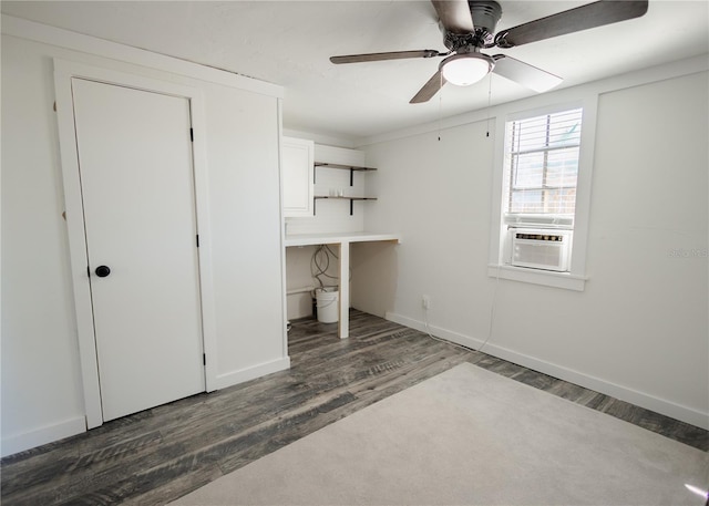 unfurnished bedroom featuring cooling unit, ceiling fan, and dark wood-type flooring