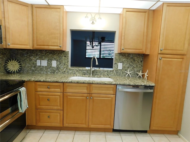 kitchen featuring appliances with stainless steel finishes, backsplash, light stone counters, and sink