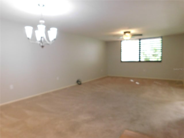 unfurnished room featuring carpet and an inviting chandelier