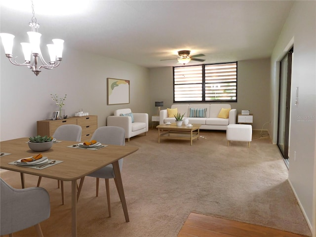 dining space featuring carpet and ceiling fan with notable chandelier