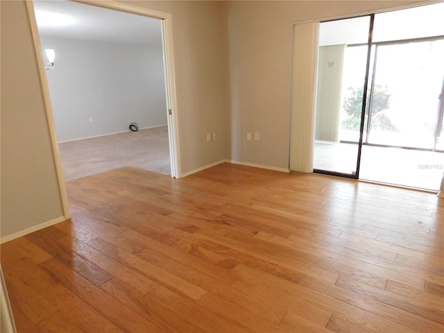 spare room featuring light hardwood / wood-style flooring