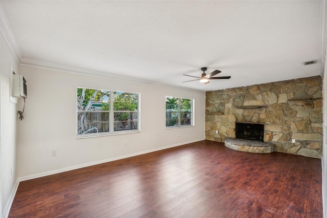 unfurnished living room featuring ceiling fan, dark hardwood / wood-style floors, an AC wall unit, crown molding, and a fireplace