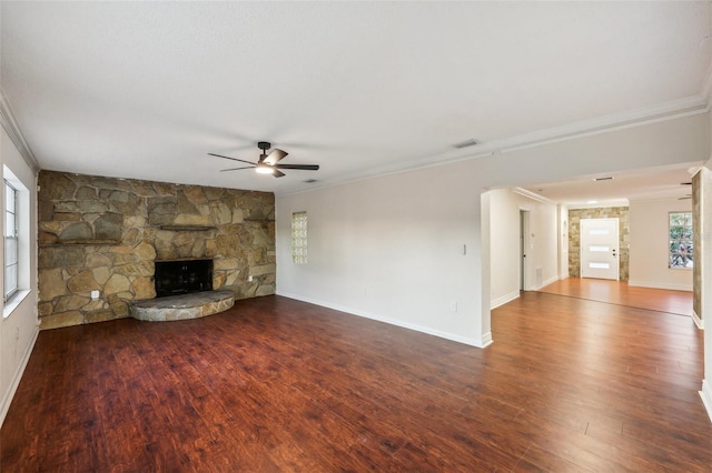 unfurnished living room with a fireplace, ceiling fan, crown molding, and hardwood / wood-style flooring