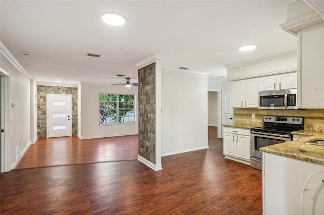 kitchen featuring white cabinetry, ceiling fan, dark wood-type flooring, light stone counters, and appliances with stainless steel finishes