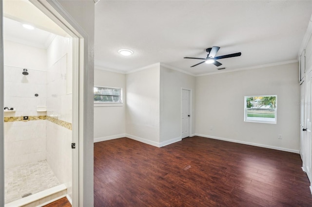 unfurnished room with ornamental molding, a wealth of natural light, and dark wood-type flooring