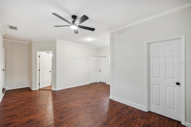 unfurnished room featuring dark hardwood / wood-style floors, ceiling fan, and crown molding