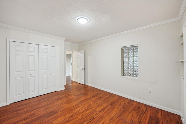 unfurnished bedroom with a closet, wood-type flooring, a textured ceiling, and ornamental molding