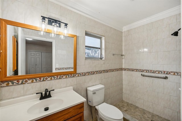 bathroom with crown molding, vanity, tile walls, and toilet