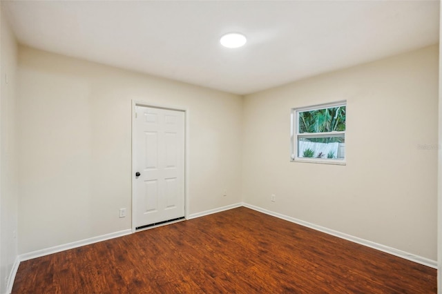 empty room with hardwood / wood-style flooring